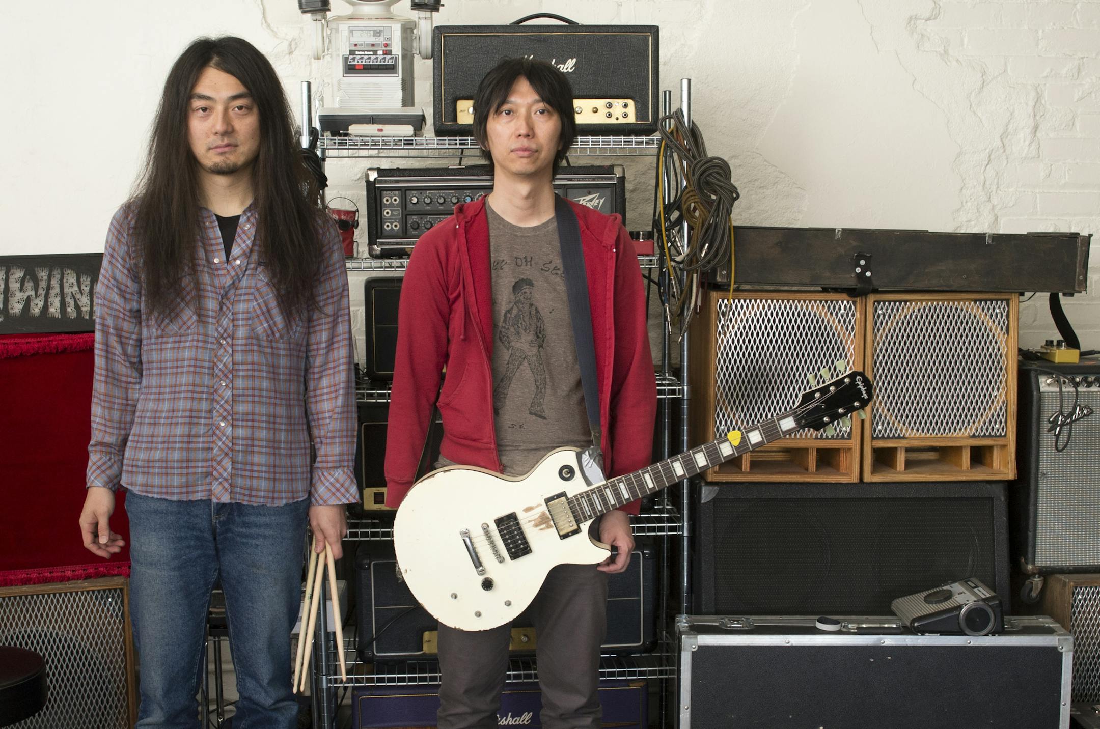 Birthday Suits singer and guitarist Hideo Takahashi, right, and drummer Matthew Kazama, are pictured in a portrait on Saturday afternoon in their practice space. ] (Aaron Lavinsky | StarTribune) aaron.lavinsky@startribune.com Singer and guitarist Hideo Takahashi and drummer Matthew Kazama, of Twin Cities punk band, the Birthday Suits, practice on Saturday, April 25, 2015 at a rehearsal space in Logan Park.