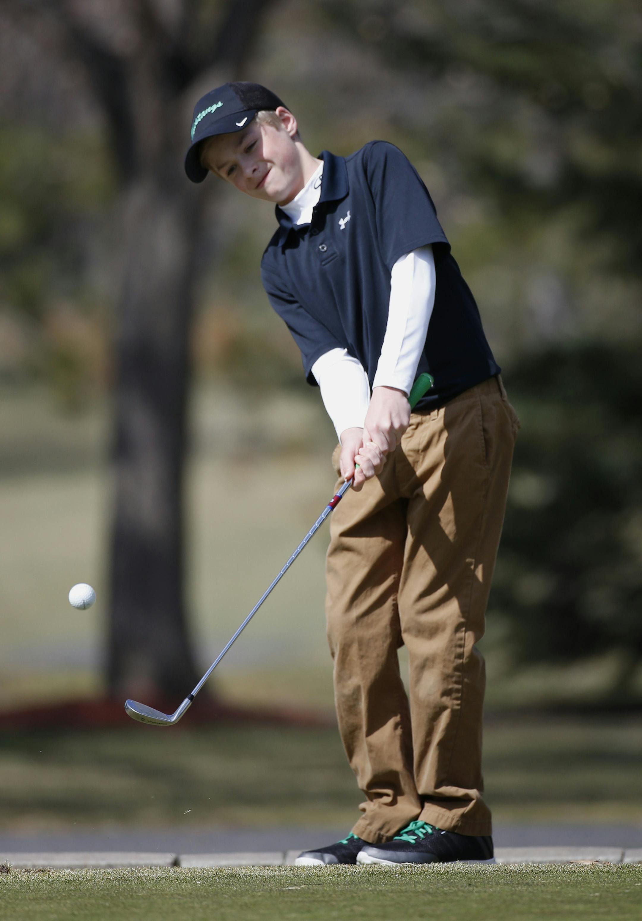 Matthew Garside chipped onto the green. ] (KYNDELL HARKNESS/STAR TRIBUNE) kyndell.harkness@startribune.com During Mounds View's golf practice at Gross National Golf Course in St. Anthony Village Min., Friday, April 10, 2014.