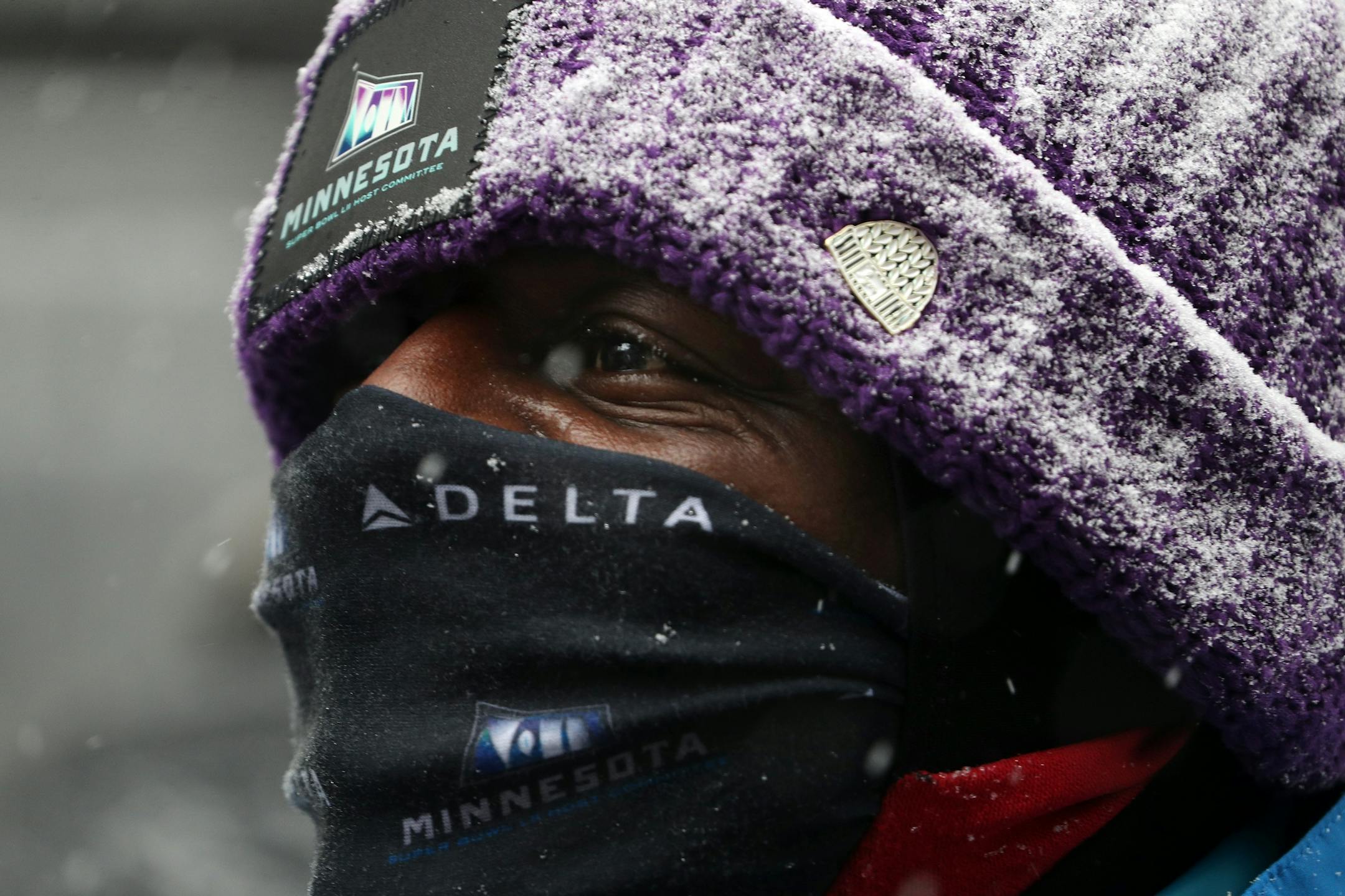 Super Bowl volunteer Timothy Ayoade peeked out from between his hat and gator as he welcomed visitors to the Super Bowl Live event on Nicollet Mall.