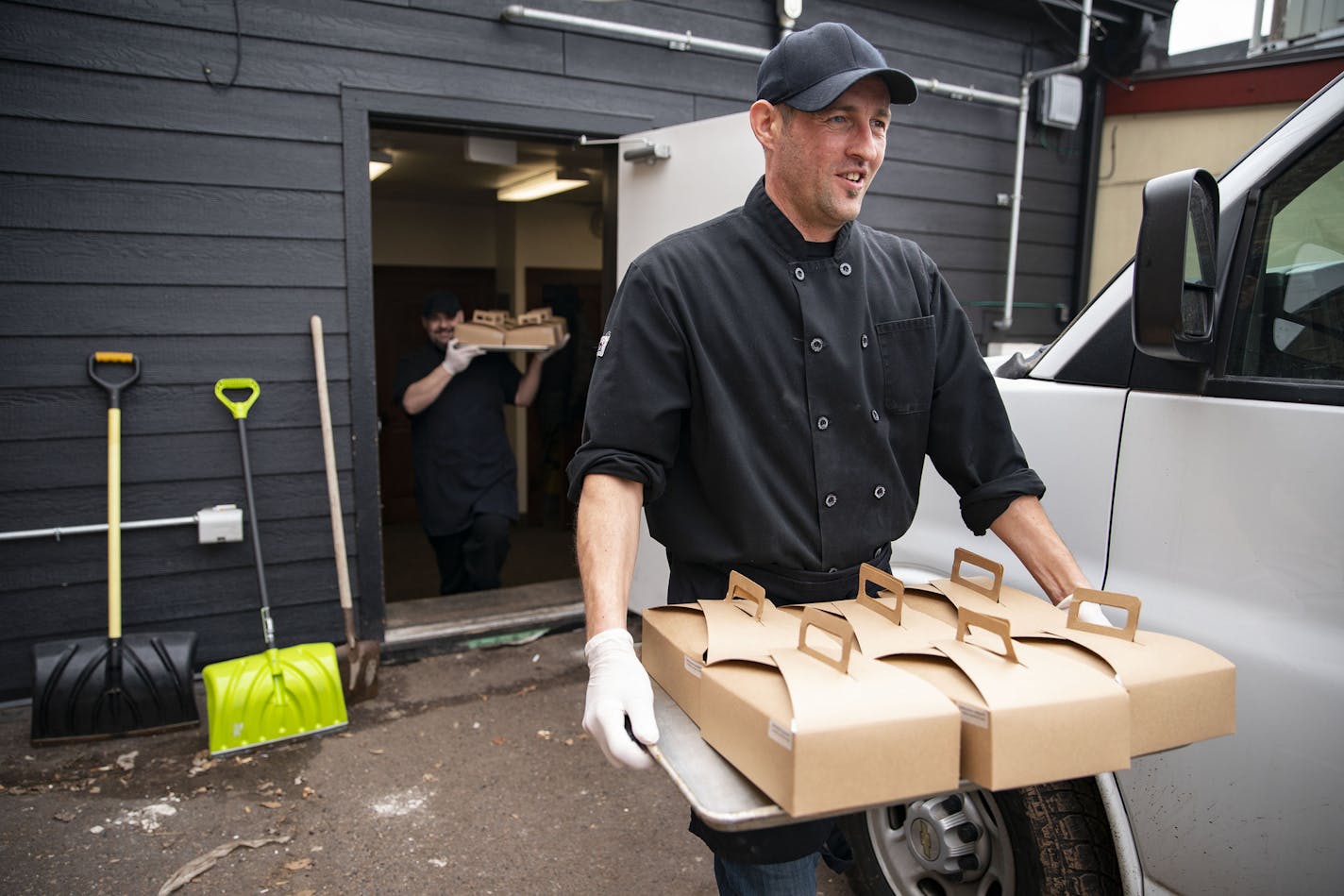 (Left) Kris Werbelow and Jonathan Reznick, kitchen manager and owner at MidCoast Catering, respectively, carried the boxed meals they prepared on Tuesday morning out to their van to be delivered to BeeHive Homes Assisted Living. ]
ALEX KORMANN &#x2022; alex.kormann@startribune.com MidCoast Catering and Yellow Bike coffee shop banded together with a judge to raise $13,000 to deliver meals to healthcare workers. They also put together small packages of food and coffee to bring to local healthcare