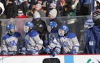 Minnetonka players on the bench, which was equipped with heaters, during the outdoor game on Jan. 19 in Bemidji.