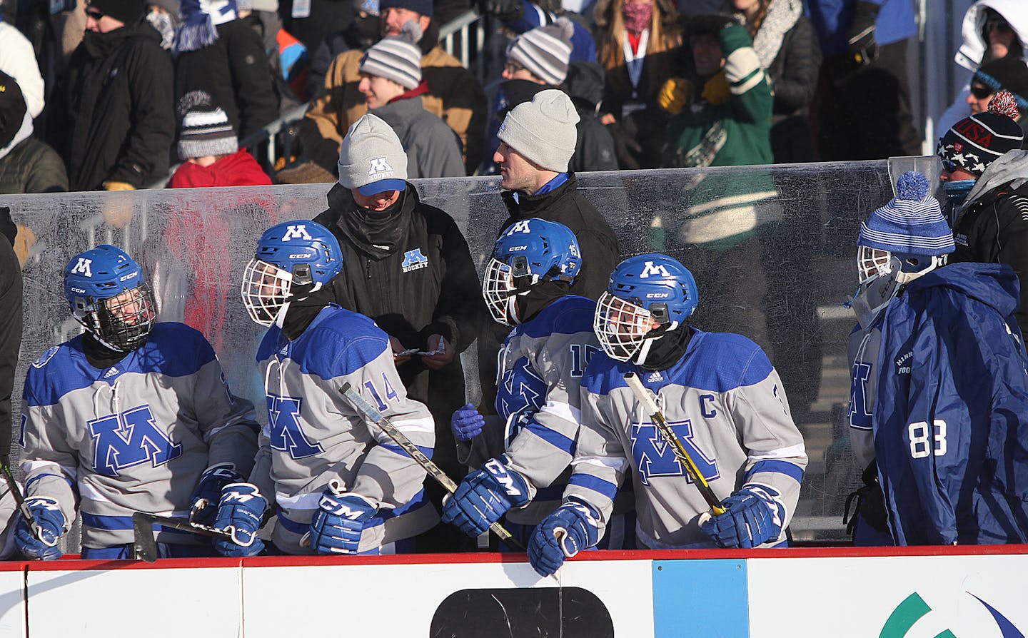 Minnetonka players on the bench, which was equipped with heaters, during the outdoor game on Jan. 19 in Bemidji.