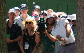 Scottie Scheffler hits from the pine straw on the third hole during third round at the Masters. Scheffler, the winner in 2022, holds a one-shot lead.