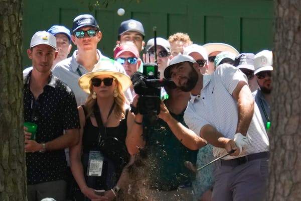 Scottie Scheffler hits from the pine straw on the third hole during third round at the Masters. Scheffler, the winner in 2022, holds a one-shot lead.