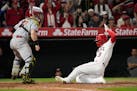 Los Angeles Angels’ Taylor Ward, right, scores on a single by Hunter Renfroe in the seventh inning.