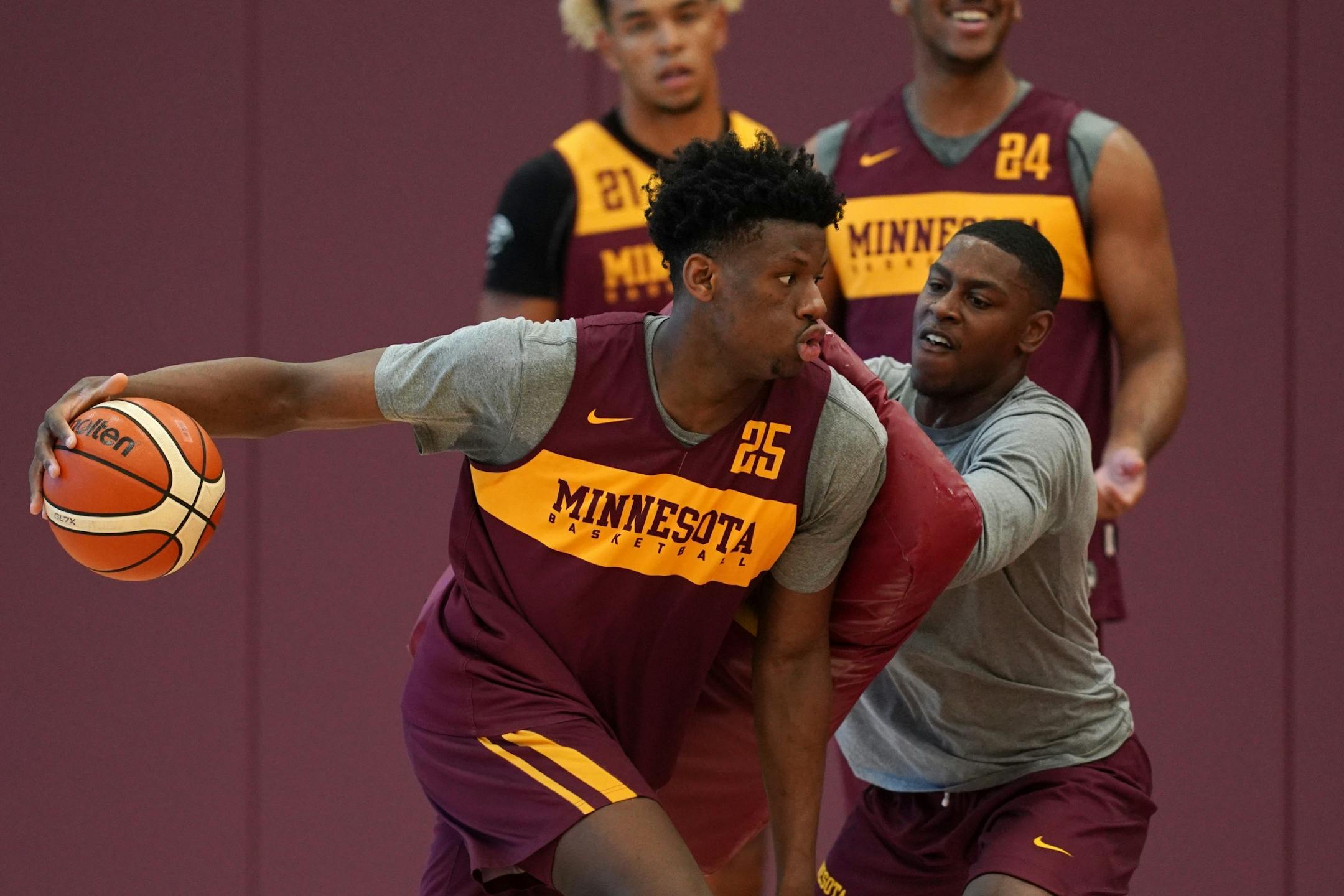 Gophers center Daniel Oturu (25) took part in a drill during Thursday's practice.