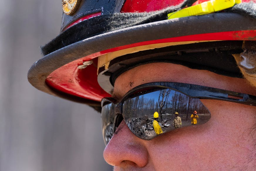 Jon Settergren, a Nisswa firefighter, talks with other firefighters and surveys the smoldered remains of a structure as part of the efforts to combat the Camp House wildfire in Brimson, Minn. on Thursday, May 15, 2025.   ]

ALEX KORMANN • alex.kormann@startribune.com
