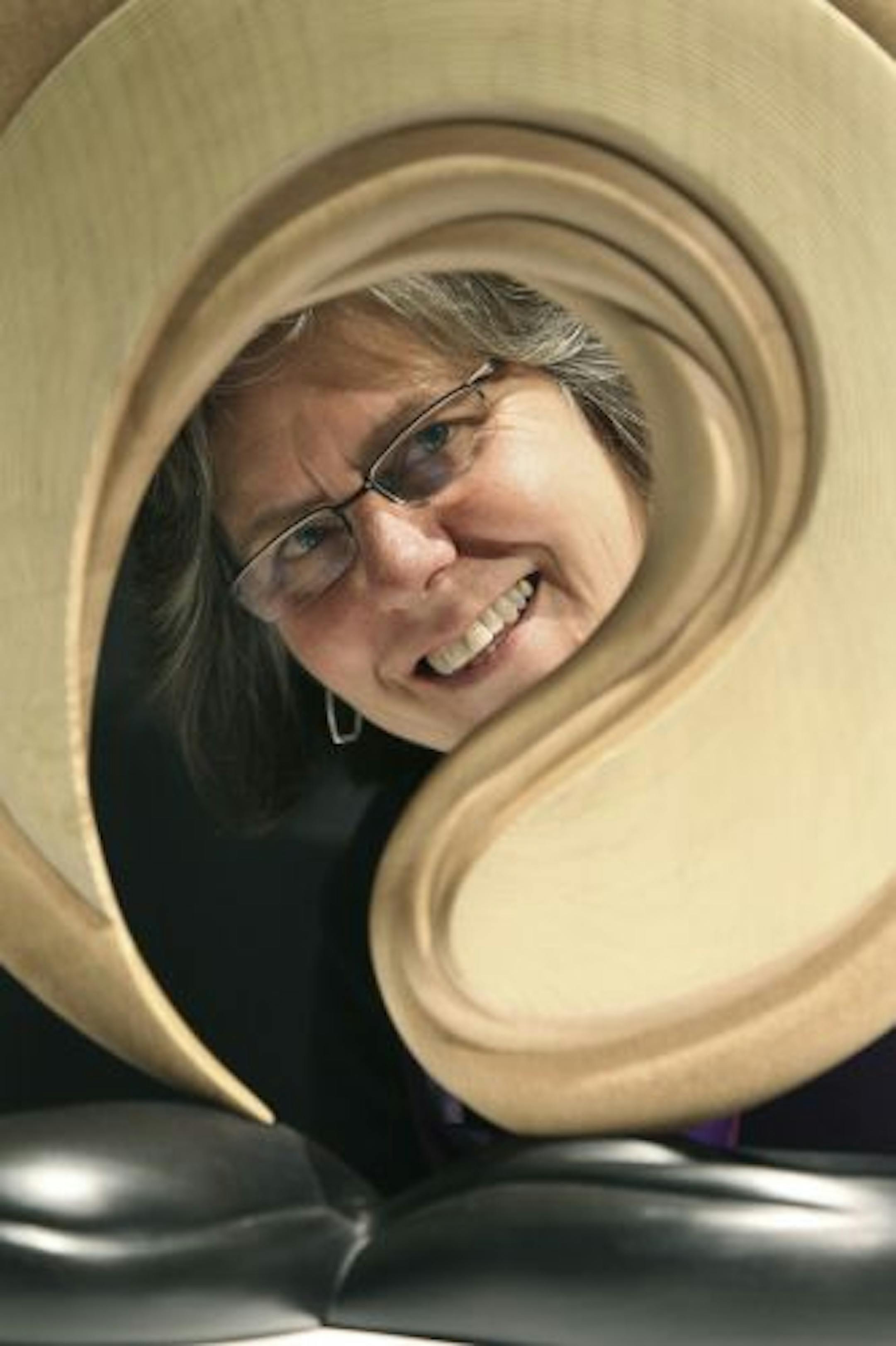Linda Tacke, who is currently the interim executive director of the American Woodturners Association, peered through one of her favorite pieces known as "Canyon Bridge" by artist Betty Scarpino. The American Woodturners Association is a group of 14,000 hobbyists who use lathes and other shop tools.