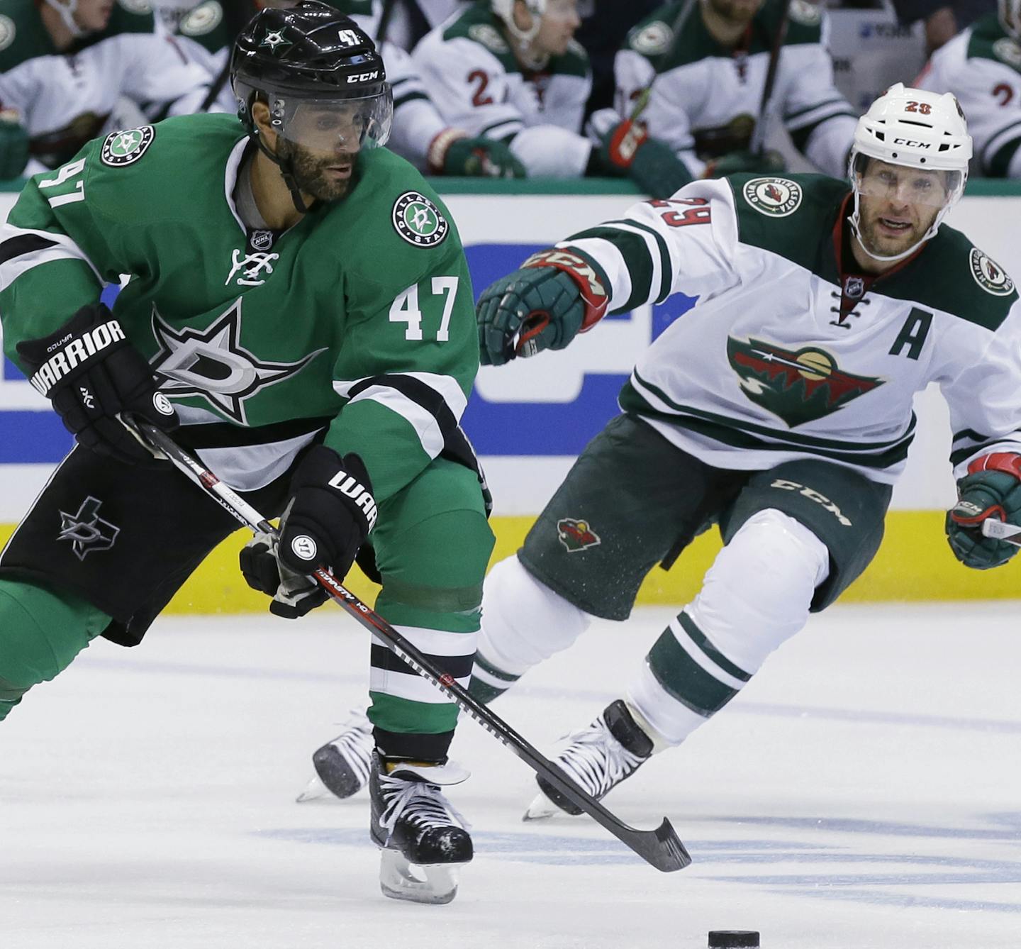 Dallas Stars defenseman Johnny Oduya (47) skates with the puck against Minnesota Wild right wing Jason Pominville (29) during the second period of Game 1 in a first-round NHL hockey Stanley Cup playoff series Thursday, April 14, 2016, in Dallas. (AP Photo/LM Otero) ORG XMIT: DNA107