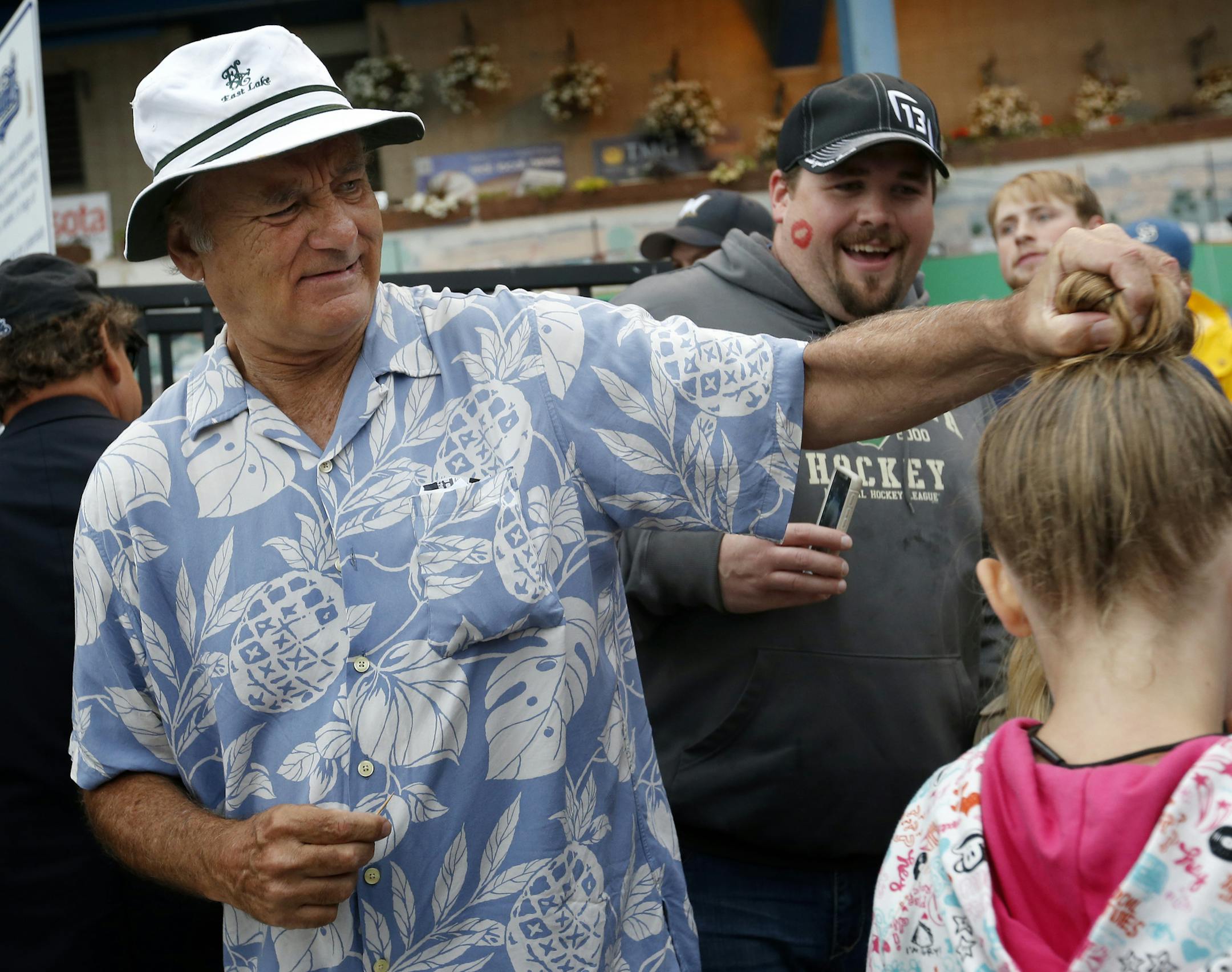 While taking tickets at the entry gate Bill Murray stopped to grab the hair bun of Audrey Beffel, 9, of Annandale. ] CARLOS GONZALEZ cgonzalez@startribune.com - August 28, 2014, St. Paul, Minn., Midway Stadium, St. Paul Saints baseball vs. Winnipeg - Final Saints game at Midway Stadium