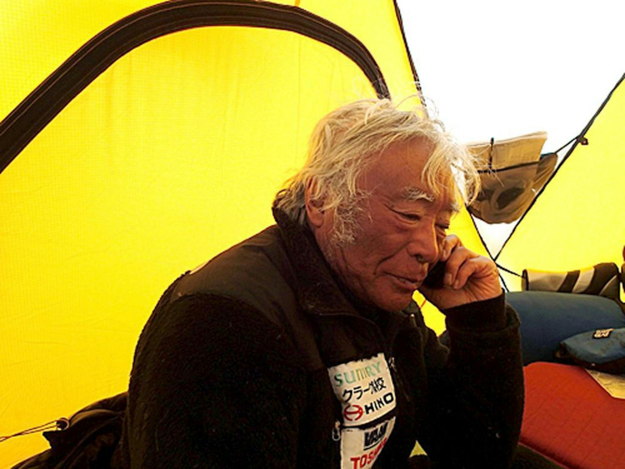 In this photo distributed by Miura Dolphins, 80-year-old Japanese extreme skier Yuichiro Miura rests in a camp at 8,000 meters (26,247 feet) during his attempt to scale the summit of Mount Everest.