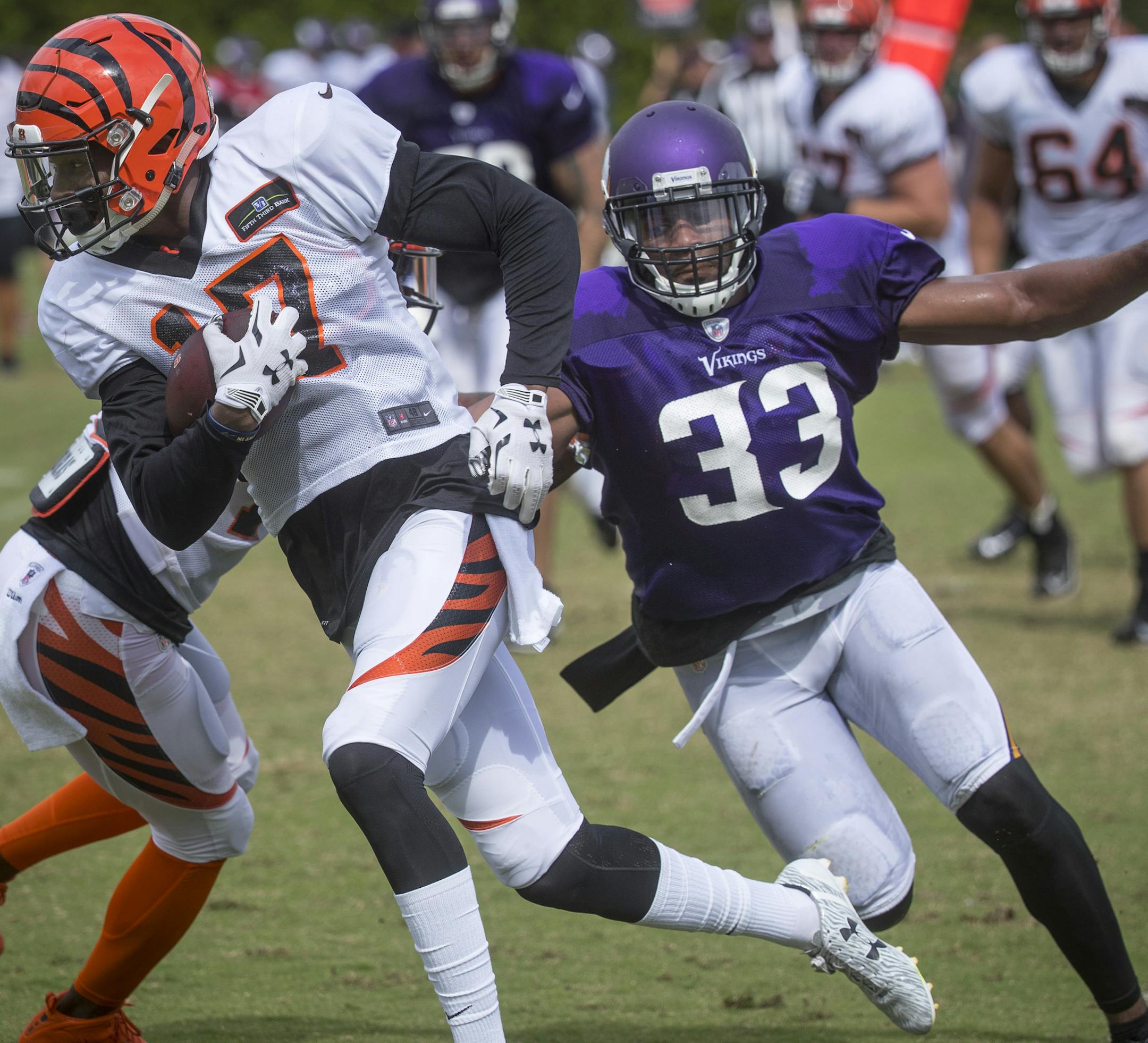 Cincinnati Bengals wide receiver Alonso Russell (17) runs the ball past Minnesota Vikings safety Michael Griffin (33) during a joint NFL football practice, Wednesday, Aug. 10, 2016, in Cincinnati. (AP Photo/John Minchillo) ORG XMIT: MIN2016082517283537