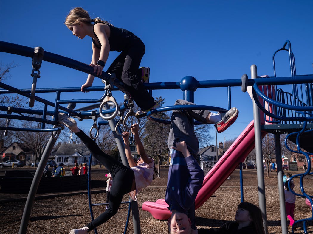 Kindergarteners and first-graders enjoyed the unseasonably warm weather on the playground at Windom Community School in Minneapolis on Wednesday.