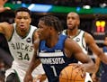 Timberwolves forward Anthony Edwards drives against Bucks forward Giannis Antetokounmpo during the first half