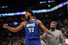 Minnesota Timberwolves center Karl-Anthony Towns (32) encourages the fans to shout at the referee after getting a technical foul in the third quarter.