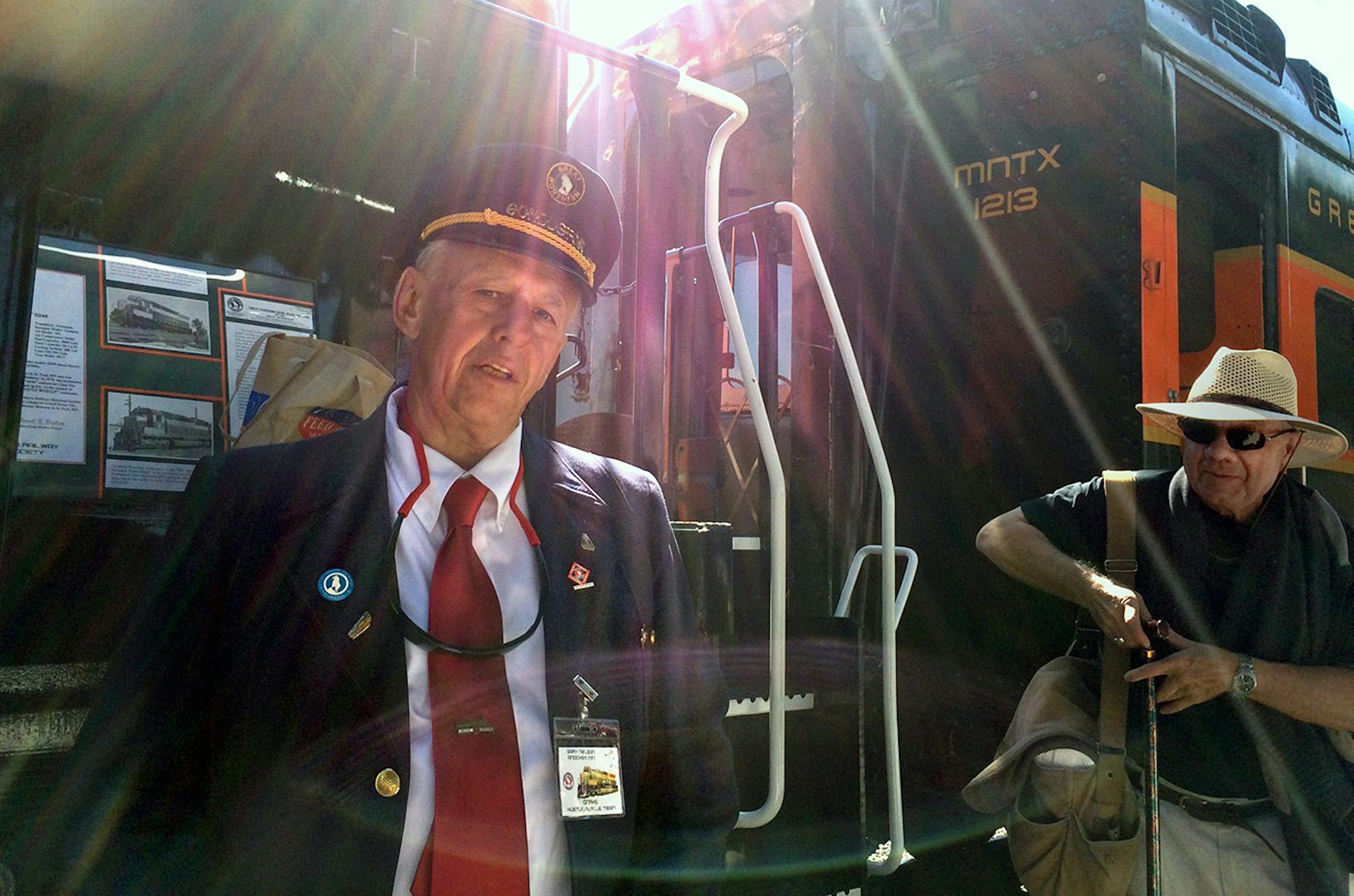 Retired Great Northern Conductor Gary Nelson shows visitors a classic locomotive, coach car and caboose on loan from the Minnesota Transportation Museum. He was hired as a brakeman in 1967 in Willmar. That was a year after this locomotive, a Great Northern 400 known as the Hustle Muscle, went into service. He first saw it when he was 21.