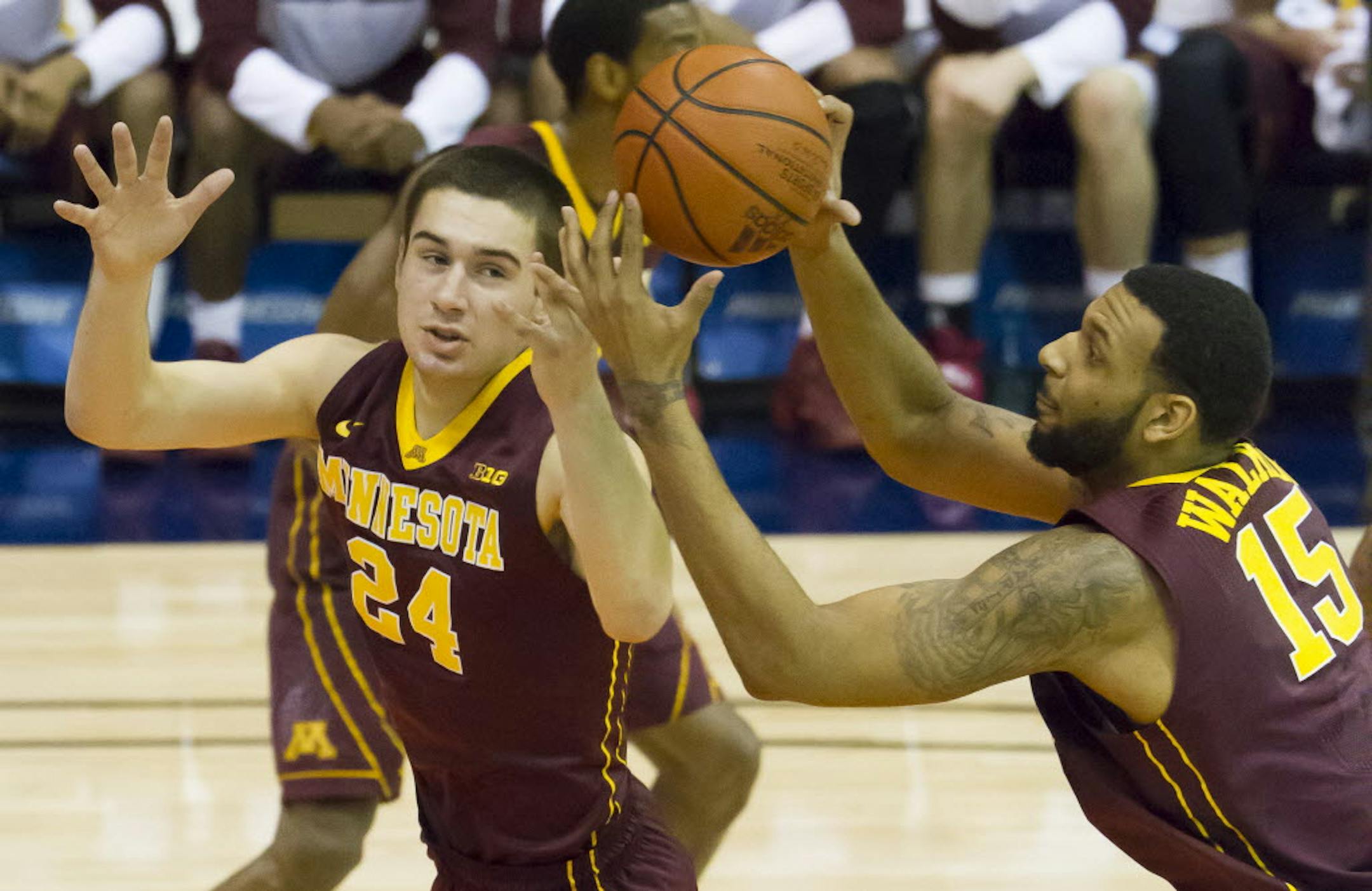 Minnesota's Joey King (24) and Maurice Walker (15) try to control a rebound while playing against Chaminade.