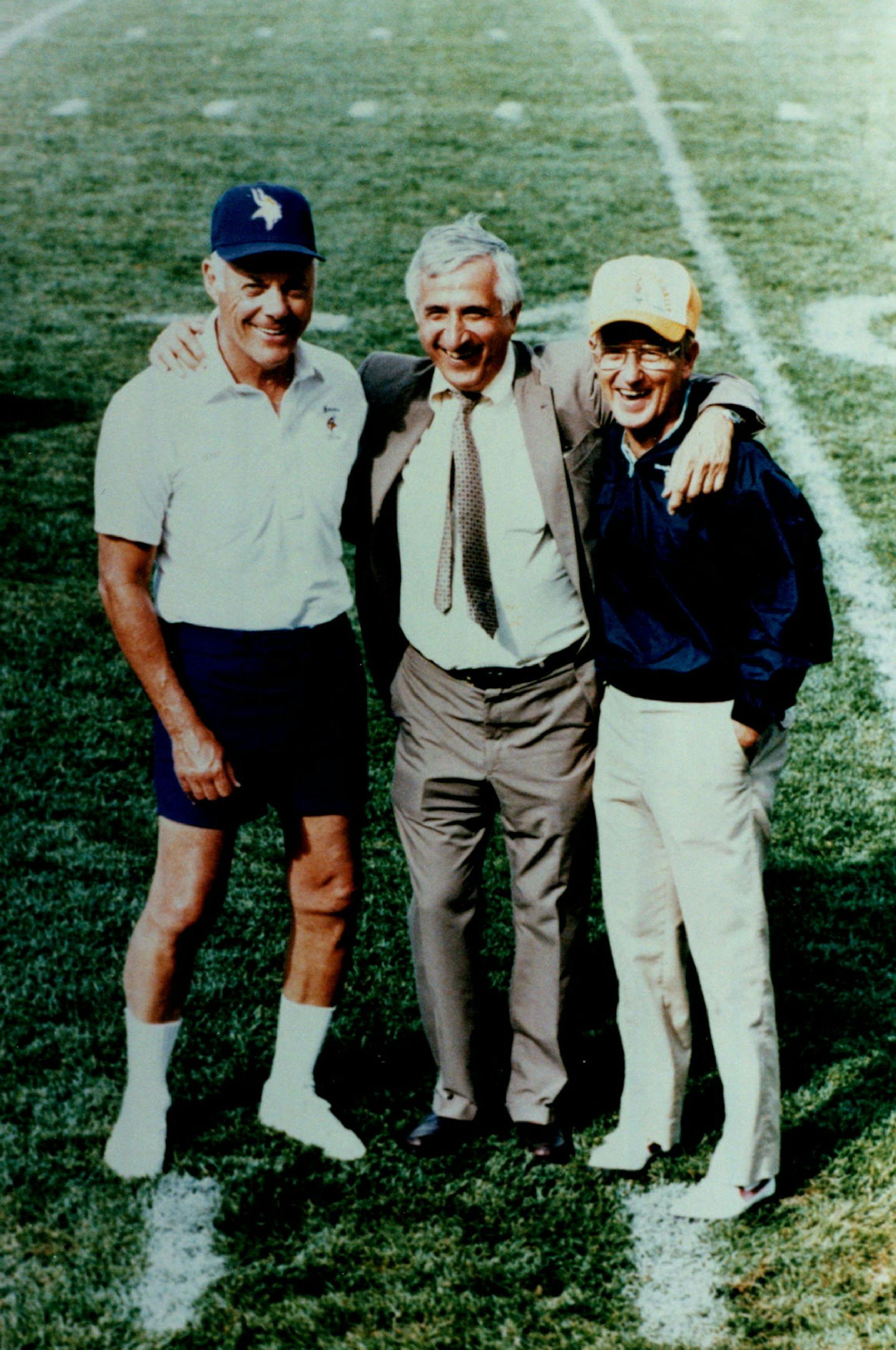 Sid Hartman (at center) at left is Bud Grant at right is Lou Holtz.