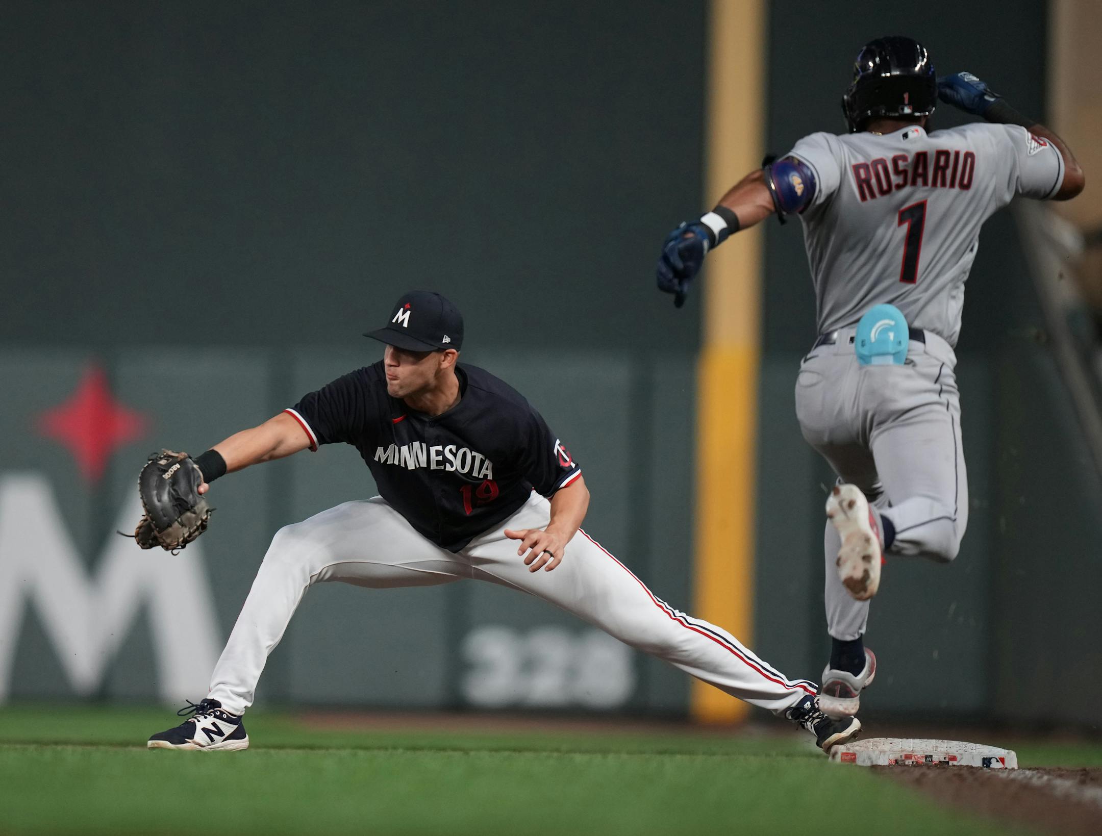 Minnesota Twins first baseman Alex Kirilloff (19) makes the stretch for the out on Cleveland Guardians shortstop Amed Rosario (1) in the 9th in Minneapolis, Minn., on Thursday, June 1, 2023.