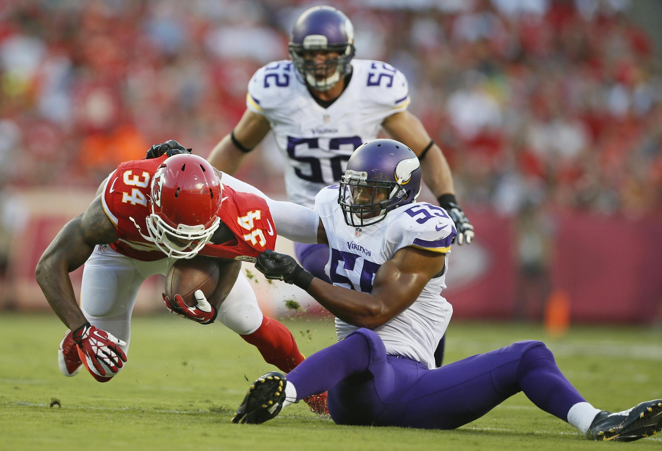 Vikings outside linebacker Anthony Barr (55) stopped Kansas City Chiefs running back Knile Davis (34) for no gain in the first quarter during a preseason game Saturday.