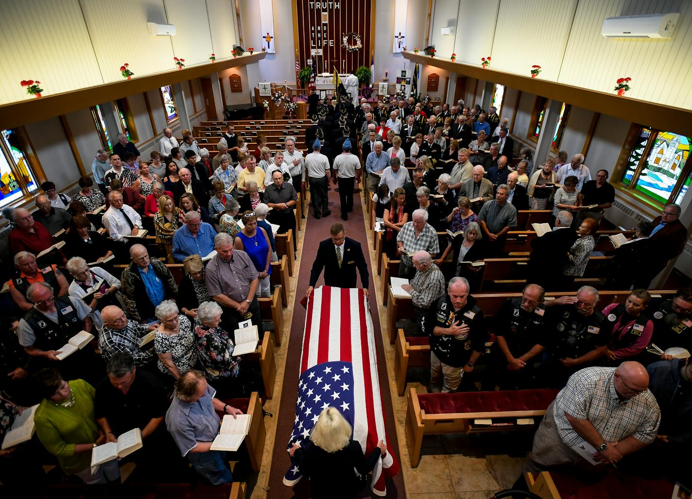 Glaydon I.C. Iverson's casket was moved into the sanctuary of Emmons Lutheran Church at the start of his funeral Saturday. ] AARON LAVINSKY &#xef; aaron.lavinsky@startribune.com Seventy-five years after Glaydon I.C. Iverson was killed aboard the USS Oklahoma at Pearl Harbor, his remains have been identified and returned home, to be buried alongside his family. We photograph the funeral ceremony and burial on Saturday, May 27, 2017 in Emmons, Minn.