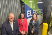 Brian Funk, chief operating officer of Metro Transit, left, with Lesley Kandaras, general manager and Carrie Desmond, manager of electric bus infrastr