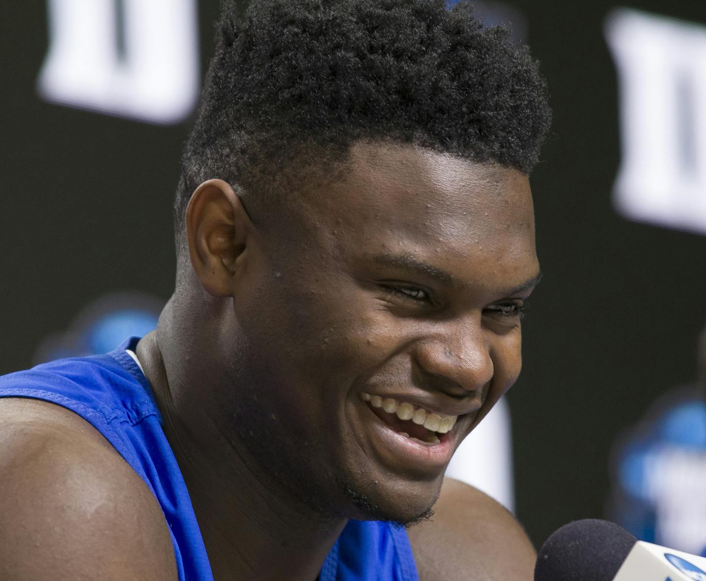 Duke forward Zion Williamson smiles as he speaks, accompanied by head coach Mike Krzyzewski, during an NCAA men's college basketball news conference in Washington, Saturday, March 30, 2019. Duke plays Michigan State in the East Regional final game on Sunday.(AP Photo/Alex Brandon) ORG XMIT: VZN113