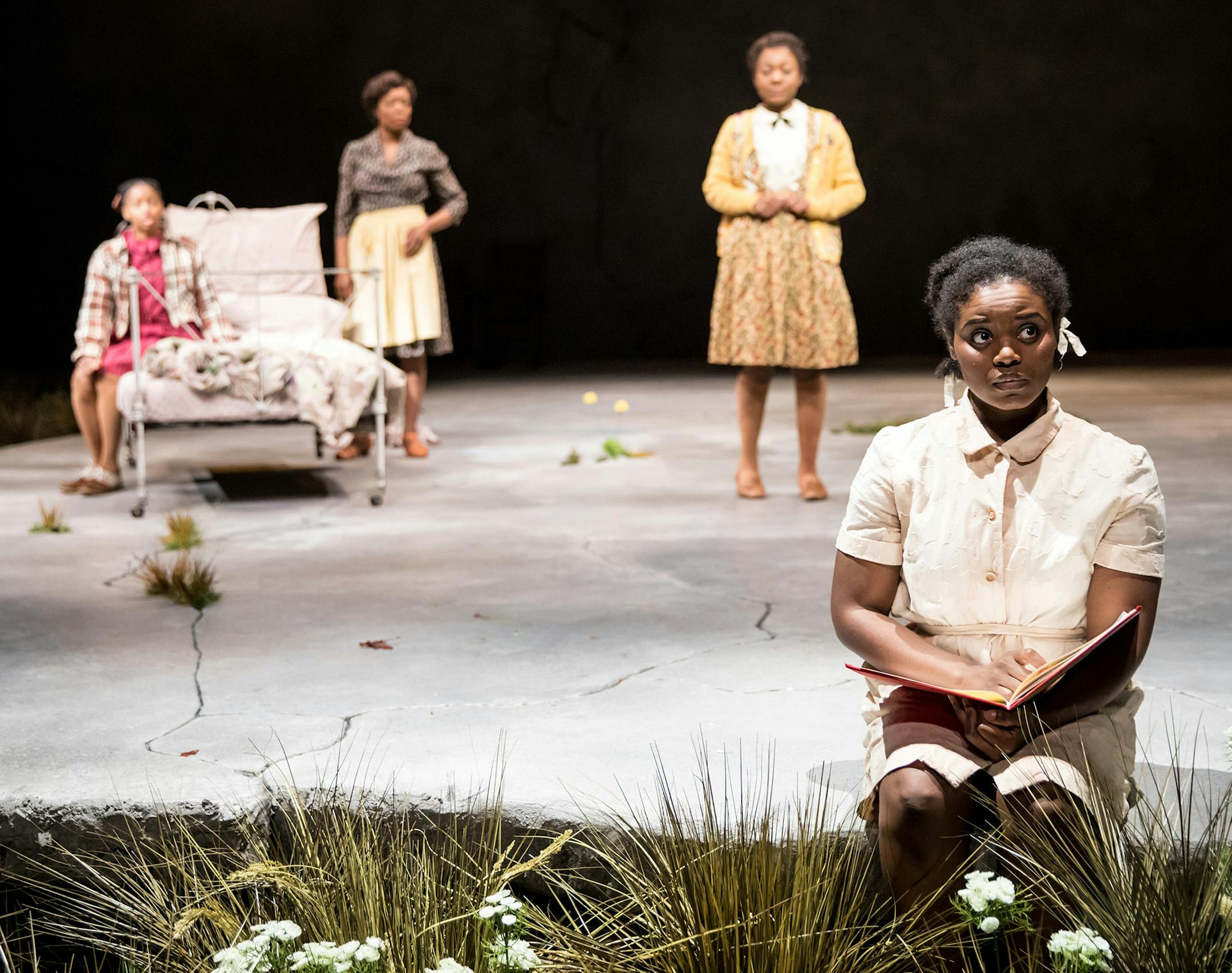 Brittany Bellizeare (Pecola), Carla Duren (Claudia), Regina Marie Williams (Mama) and Deonna Bouye (Frieda) in the Guthrie Theater&#xed;s production of Toni Morrison&#xed;s "The Bluest Eye." Playing April 15 - May 21, 2017 on the Wurtele Thrust Stage at the Guthrie Theater. Photo by Dan Norman.