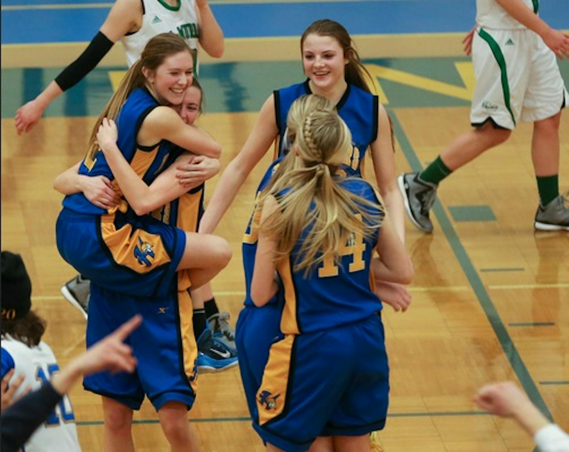 Hastings girls basketball players hugged after winning a close match against Hill-Murray at Hastings High School on Feb. 24, 2015.