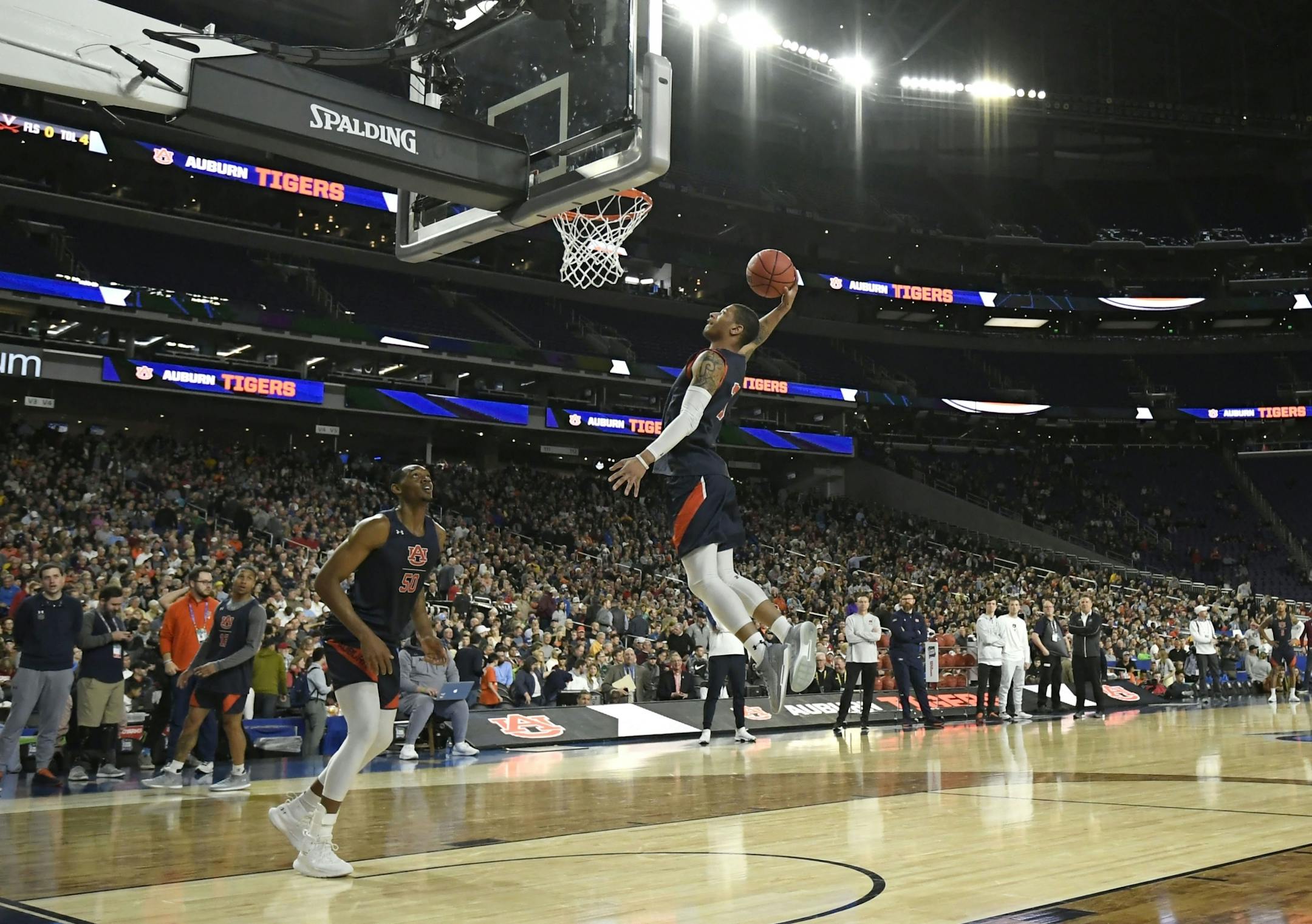 Auburn guard Samir Doughty (10) dunked near teammate Austin Wiley (50) during open practice in front of thousands of fans Friday at U.S. Bank Stadium.