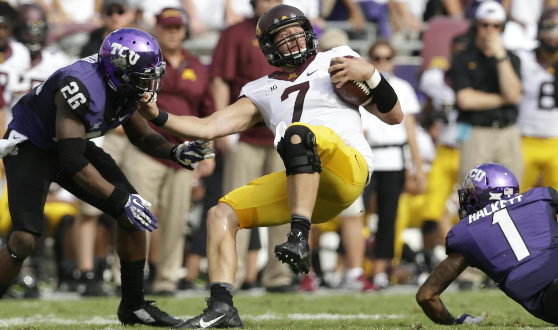 Minnesota quarterback Mitch Leidner (7) is stopped by TCU safety Chris Hackett (1) and safety Derrick Kindred (26) during the first half of an NCAA college football game, Saturday, Sept. 13, 2014, in Fort Worth, Texas. (AP Photo/LM Otero) ORG XMIT: TXMO109