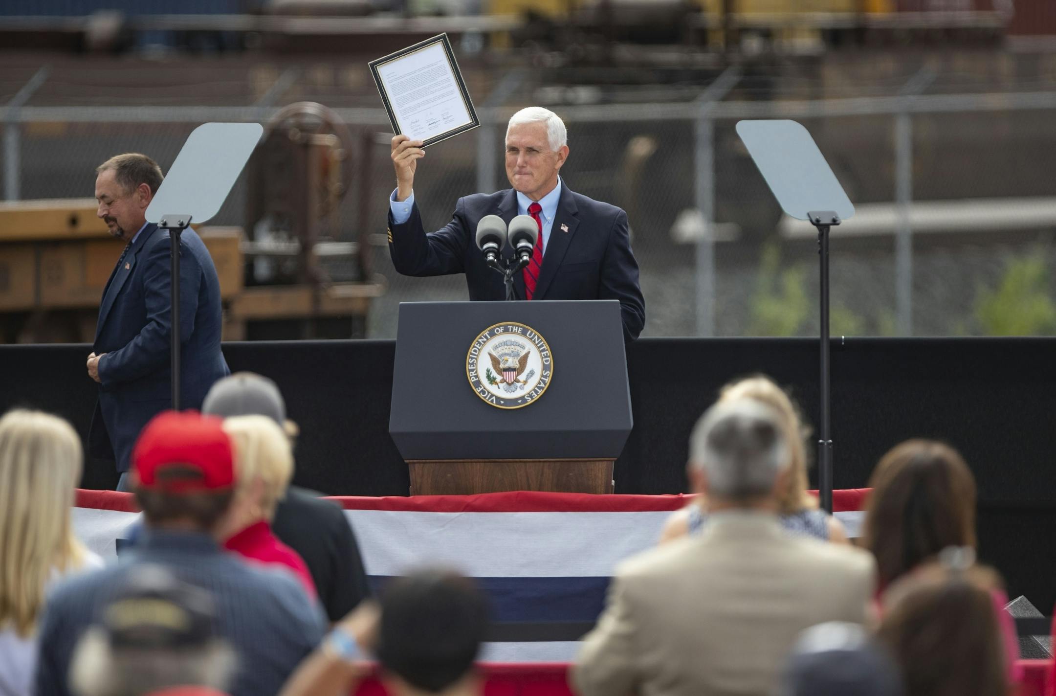 Vice President Mike Pence held up a declaration to endorse Donald Trump for president that was signed by six Iron Range cities mayors during his campaign event on Friday.