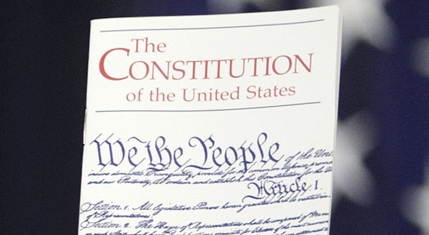 FILE - In this March 23, 2016 photo, the Constitution is held by a member of Congress on Capitol Hill in Washington. President Donald Trump says he wants to order the end of the constitutional right to citizenship for babies of non-citizens and unauthorized immigrants born in the United States. (AP Photo/J. Scott Applewhite)