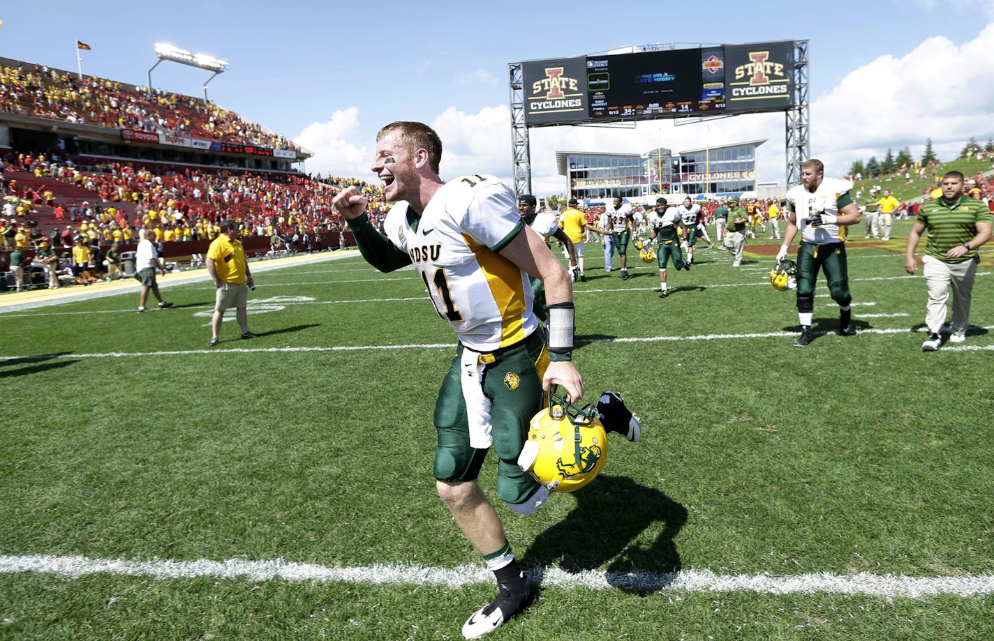 North Dakota State quarterback Carson Wentz runs off the field after their 34-14 win over Iowa State in an NCAA college football game, Saturday, Aug. 30, 2014, in Ames, Iowa. (AP Photo/Charlie Neibergall)