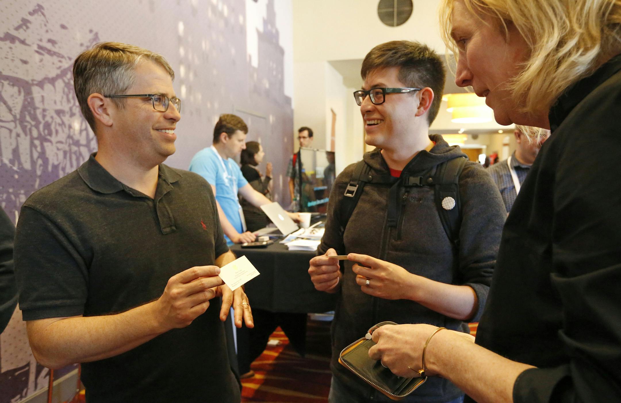Matt Cutts, U.S. Digital Service acting administrator, left, exchanges cards with Ted Han from Oakland and Veda Cook from Berkeley, right, at the Code For America Summit at the Oakland Marriott Convention Center in Oakland, Calif., on May 31, 2018. Cutts is in THE Silicon Valley/Bay Area to recruit tech workers to come work with him in Washington, D.C. (Laura A. Oda/Bay Area News Group/TNS)