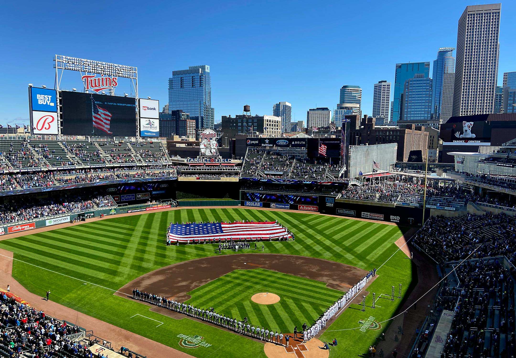 Players stood for the National Anthem before the game at Target Field, in Minneapolis, Minn., on April 8, 2022. The Minnesota Twins take on the Seattle Mariners for their season opener. ] Elizabeth Flores • liz.flores@startribune.com