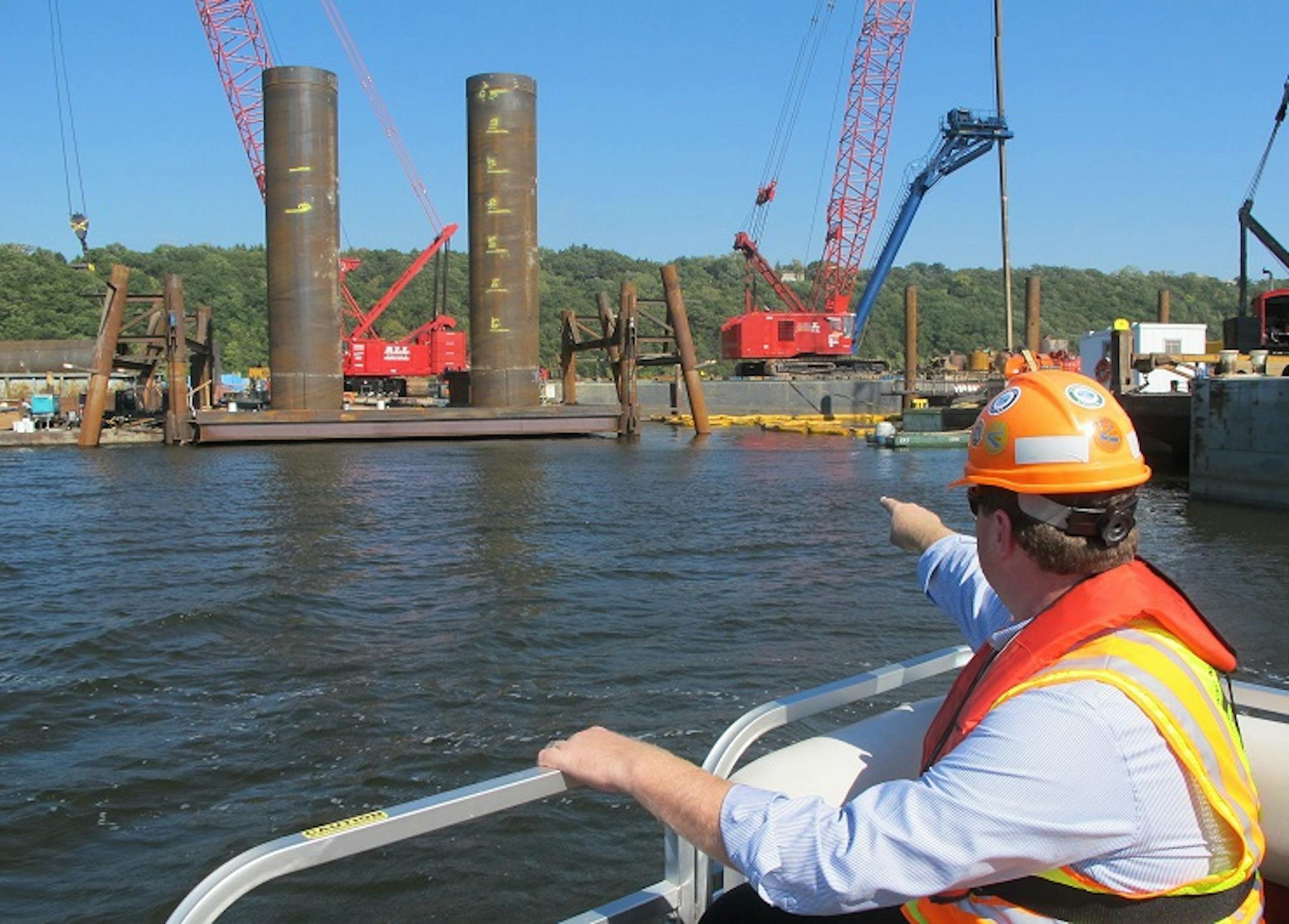 Piers for a new St. Croix River bridge rise out of the water at one of the barges where crews have drilled footings deep in the bedrock. Jon Chiglo (foreground), project manager for the Minnesota Department of Transportation, said good weather has allowed the work to move quickly. "Once it ices over they're probably pretty much done for the winter," he said.