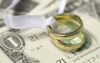Wedding rings on cash marriage money finance istockphoto.com