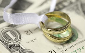 Wedding rings on cash marriage money finance istockphoto.com