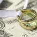 Wedding rings on cash marriage money finance istockphoto.com