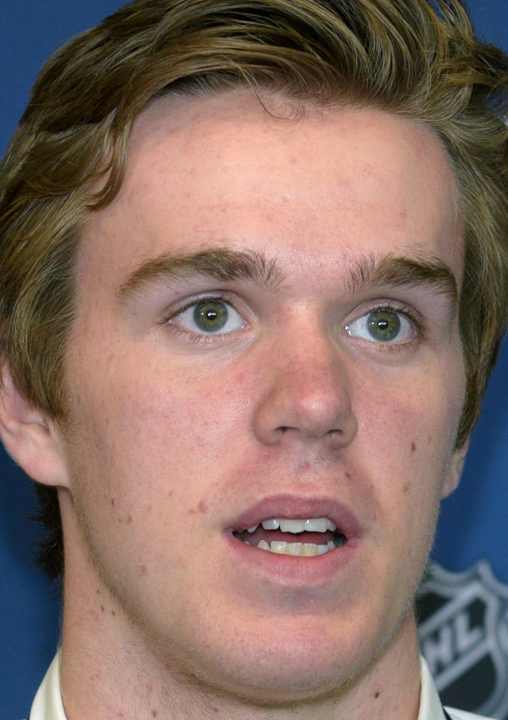Connor McDavid answers a question about playing in the National Hockey League during a news conference at the NHL Combine, Friday, June 5, 2015, in Buffalo, N.Y. (AP Photo/Gary Wiepert) ORG XMIT: MIN2015062518223372
