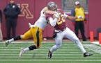 Minnesota's wide receiver Jeff Borchardt was taken down by Iowa's defensive back John Lowdermilk in the third quarter as the Gophers took on the Iowa 