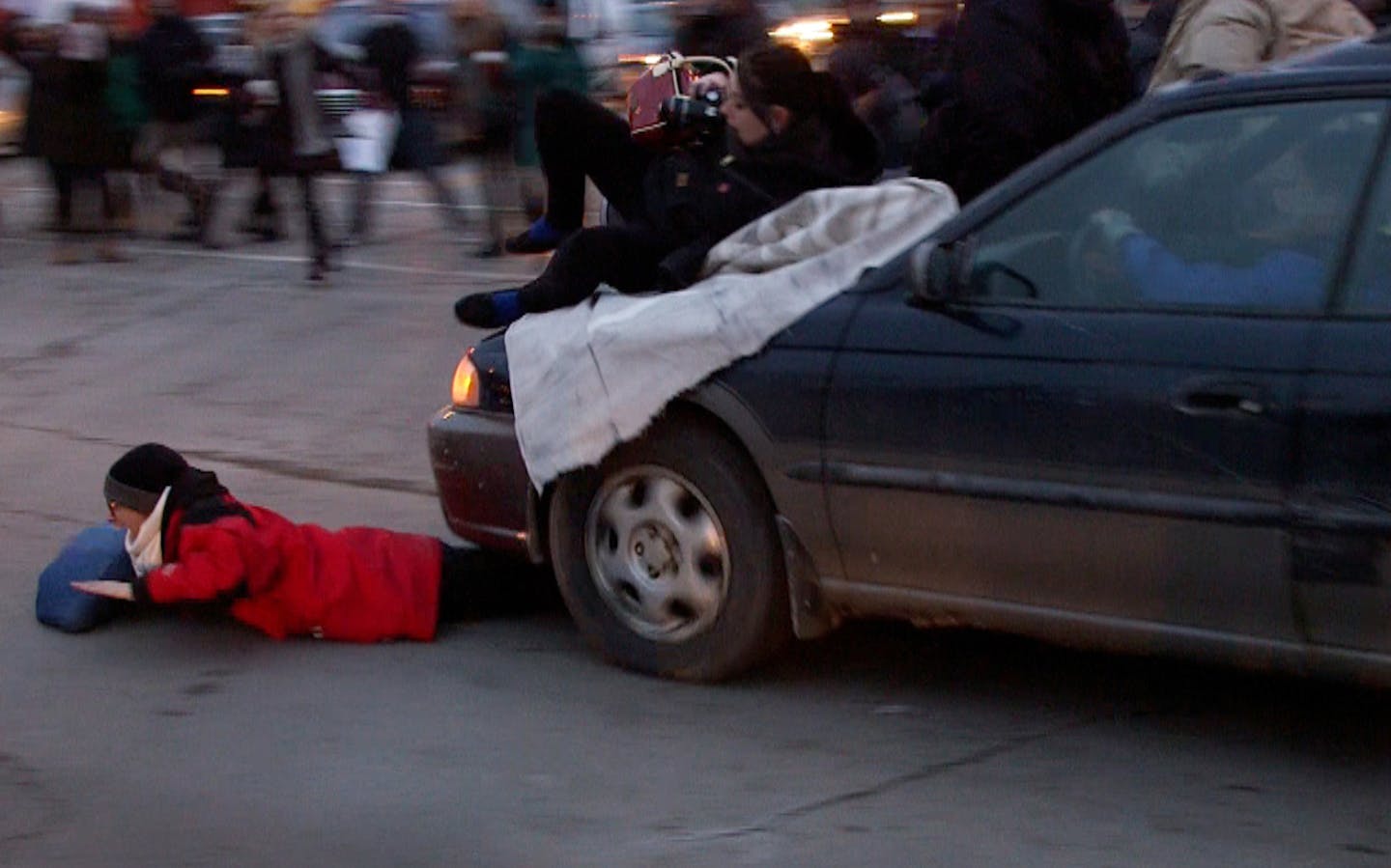 A car plowed through a Ferguson rally in South Minneapolis after protesters blocked the intersection of Lake Street and Minnehaha Ave on Tuesday, Nov. 25, 2014.