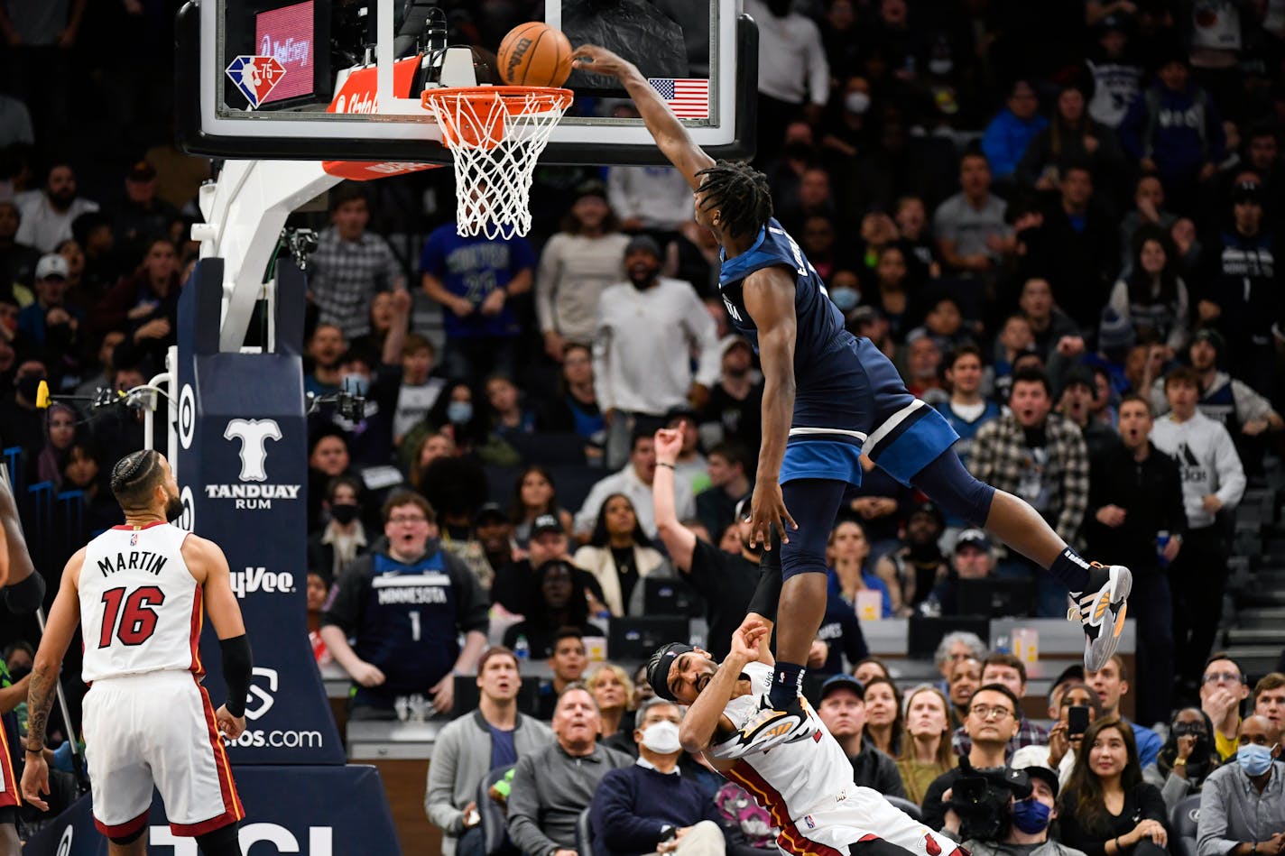 Timberwolves guard Anthony Edwards is called for an offensive foul as he leaps over Miami guard Gabe Vincent