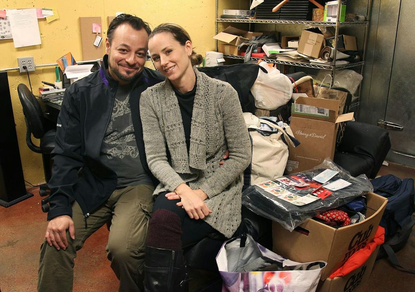 The owners of Amore Victoria restaurant, Alex and Jenna Victoria, sat surrounded by donations that patrons have been dropping off to help the victims of a condo fire. The restaurant will host a fundraising event next Wednesday.