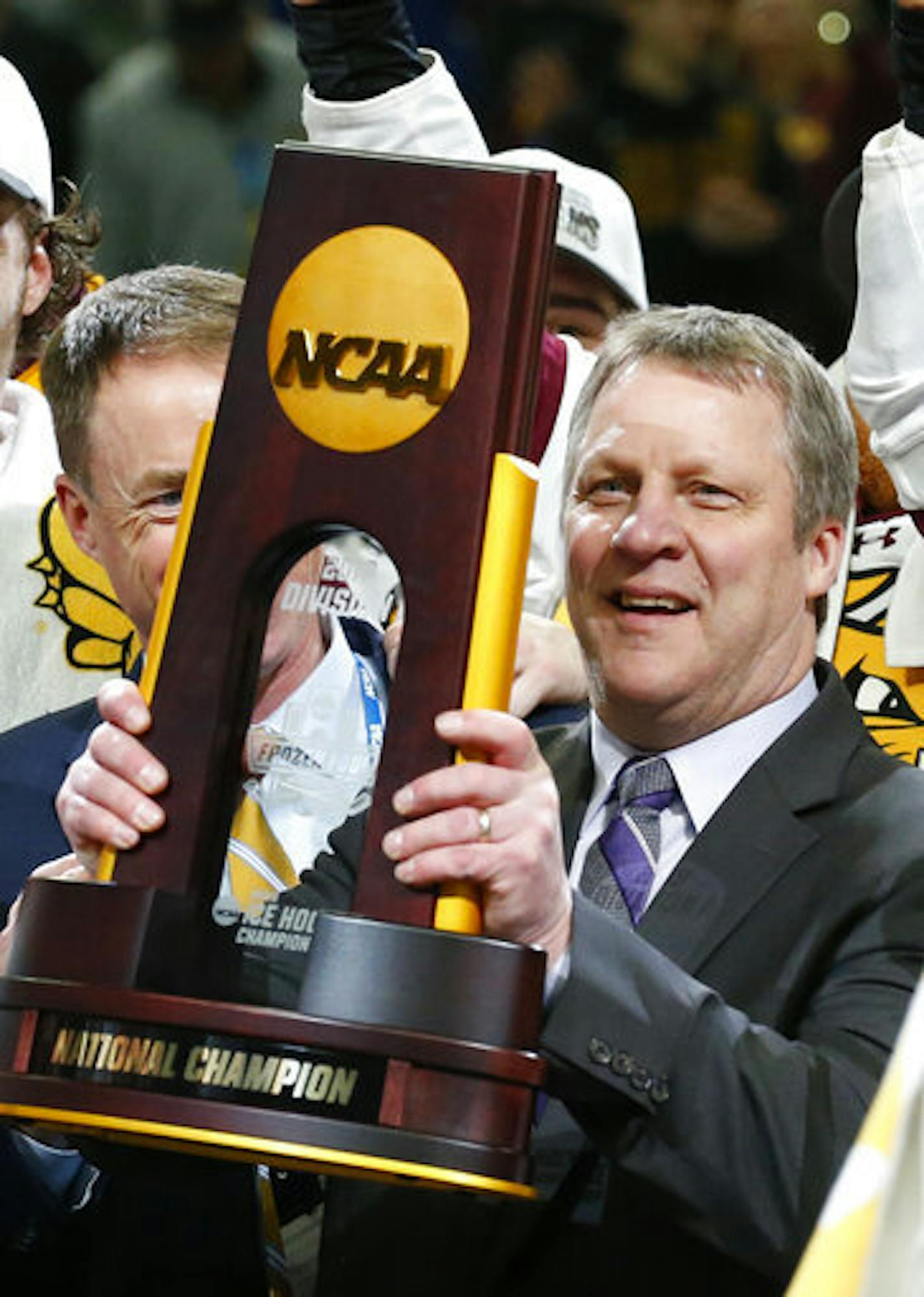 Minnesota-Duluth coach Scott Sandelin celebrates the team's 3-0 victory over Massachusetts in the NCAA Frozen Four men's college hockey championship game Saturday, April 13, 2019, in Buffalo, N.Y. (AP Photo/Jeffrey T. Barnes) ORG XMIT: NYJB117