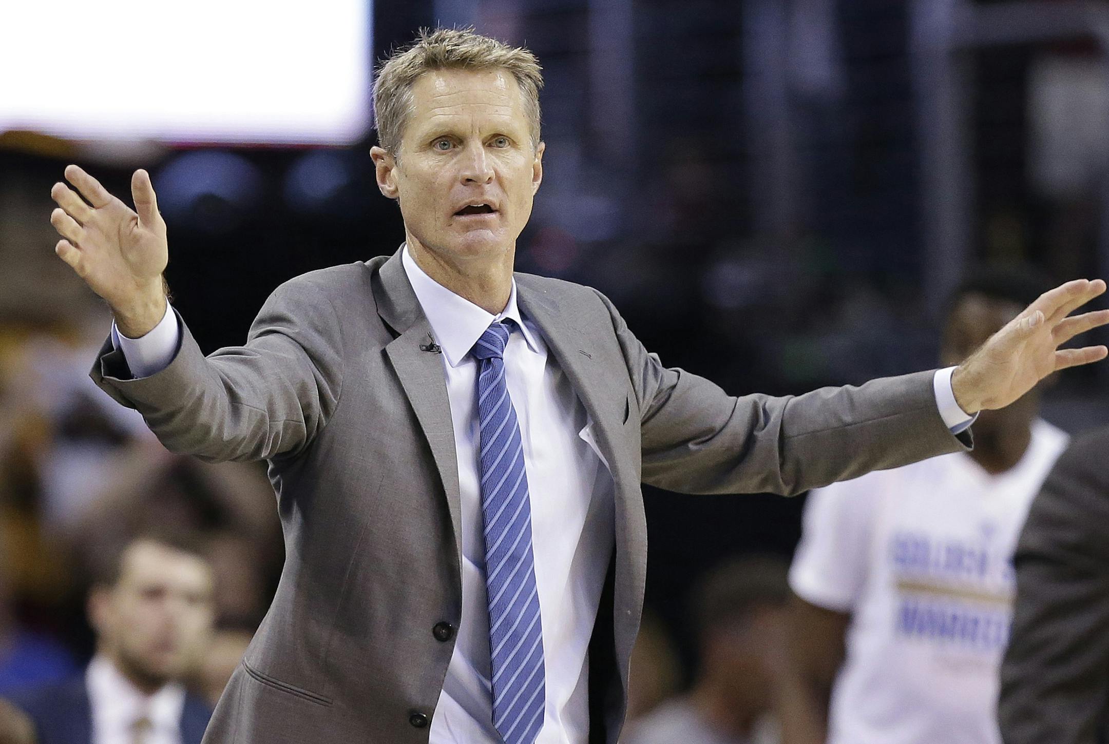 Golden State Warriors head coach Steve Kerr reacts as he watches from the bench during the second half of Game 4 of basketball's NBA Finals against the Cleveland Cavaliers in Cleveland, Thursday, June 11, 2015. (AP Photo/Tony Dejak)