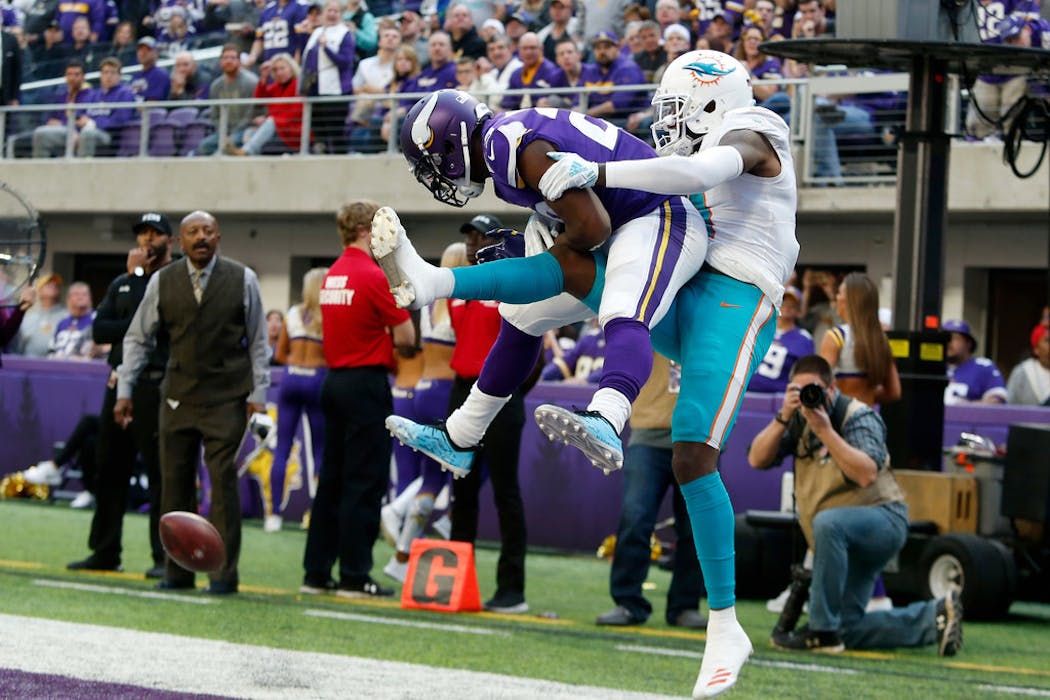 Vikings cornerback Xavier Rhodes breaks up a pass intended for Dolphins wide receiver DeVante Parker