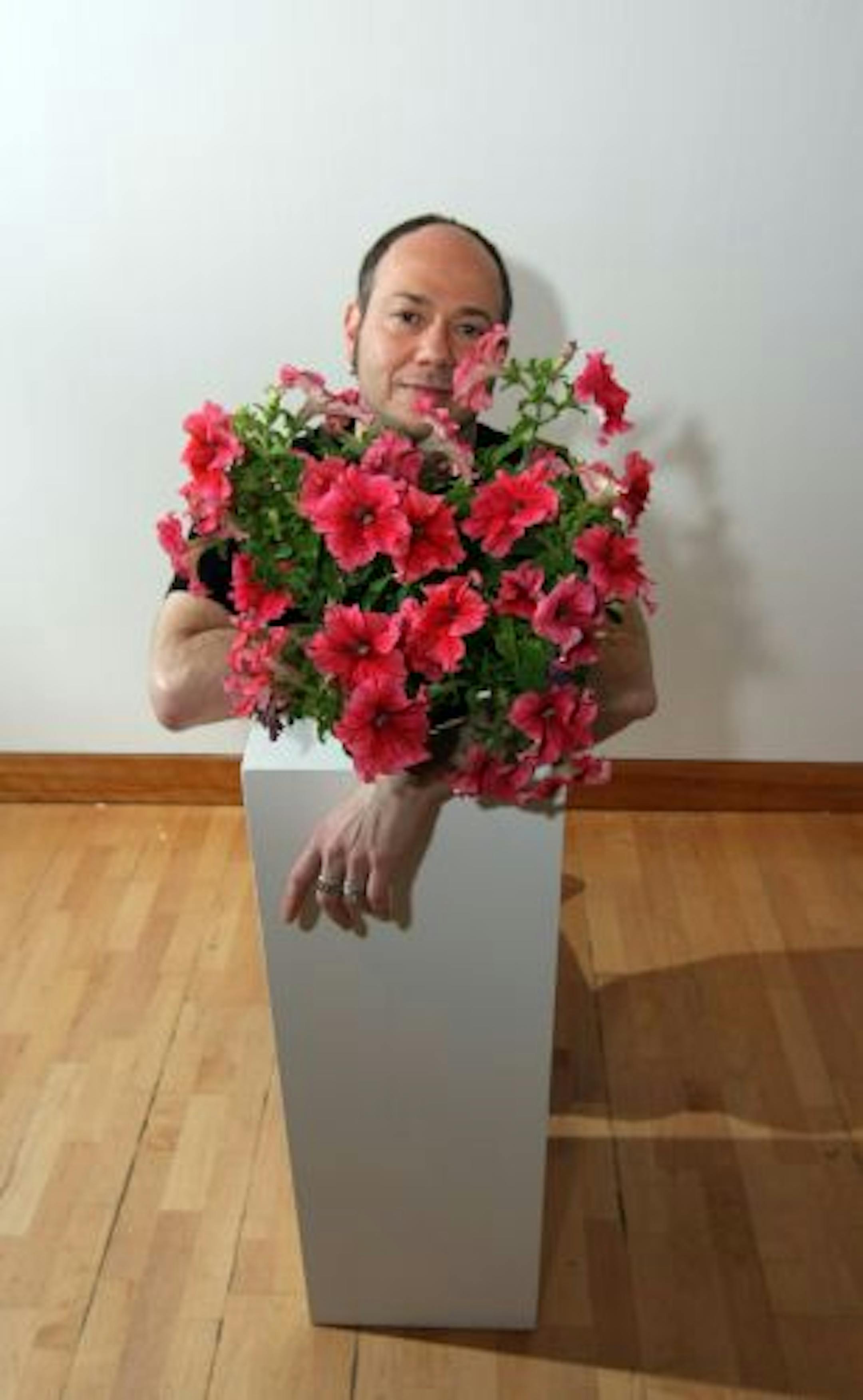 Eduardo Kac's genetically modified petunia is what he calls a "plantimal." He created it with the help of U of M molecular biologist Neil Olszewski.