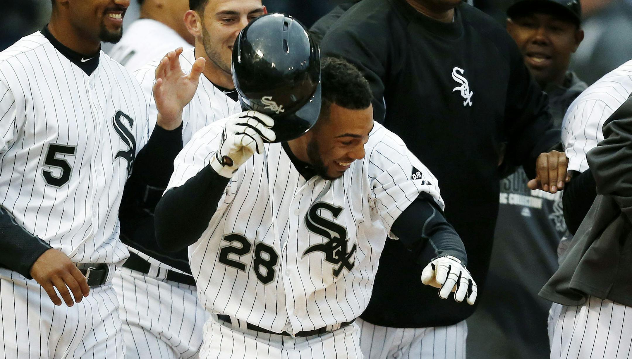 Chicago White Sox's Leury Garcia (28) celebrates with teammates after scoring to end a baseball game against the Minnesota Twins in the eleventh inning on Wednesday, April 2, 2014, in Chicago. The White Sox won 7-6. (AP Photo/Andrew A. Nelles)
